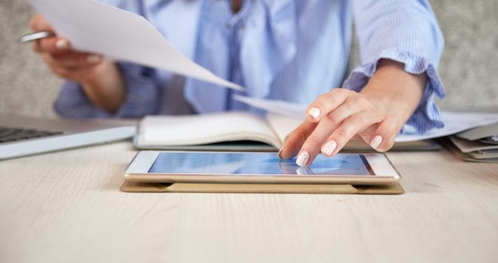 mid section unrecognizable woman working with tablet pc office desk