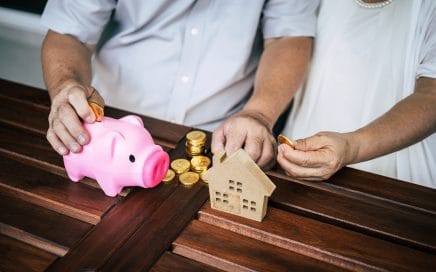 Elderly Couples talking about finance with piggy bank